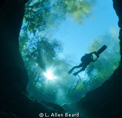 Cave diver riding scooter over Devil's Eye, Ginnie Spring... by L. Allen Beard 